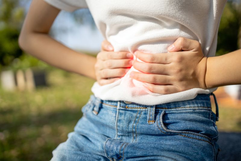 Woman holding her stomach in pain