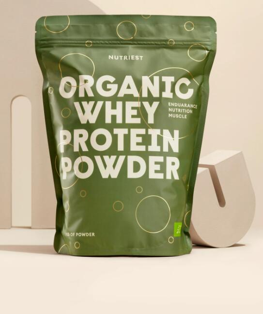 A green bag of organic whey protein powder on a table